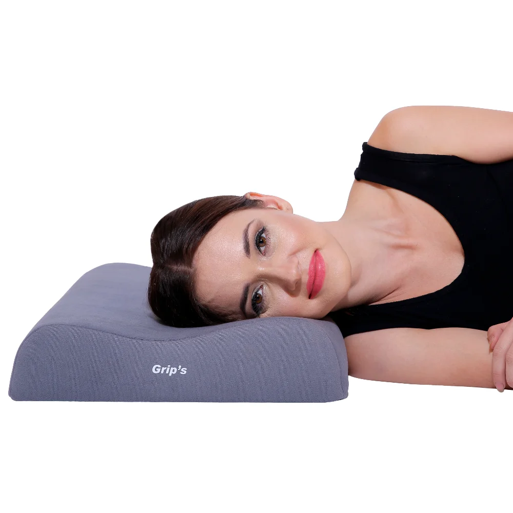 Cervical Pillow – Contoured | Ergonomic Neck Support Pillow | Grip India 1 The <strong>Grip India Cervical Pillow – Contoured</strong> is made from high-quality PU foam and features a unique contoured cervical roll design to provide comfortable support to the cervical spine while sleeping. Its ergonomic shape is designed to accommodate the shoulder and upper arm during side sleeping, while the soft fabric covering enhances comfort. Available in a universal size. Cervical Pillow – Contoured